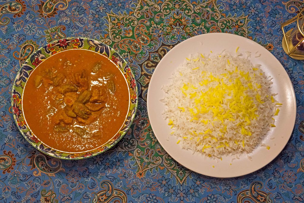Persian Bamyeh stew with okra and meat served with rice in a Persian restaurant in Madrid