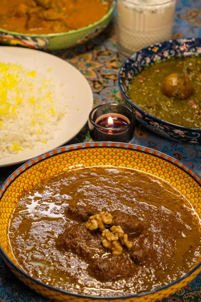 Traditional Persian stews at PARSI Persian and Halal Restaurant in Madrid, featuring Fesenjan with pomegranate and walnuts and Ghormeh Sabzi served with basmati rice